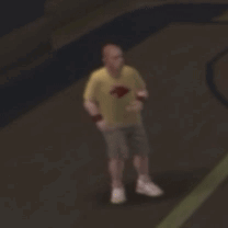 A Blurry Picture Of A Man In A Yellow Shirt And Shorts Standing On A Basketball Court . GIF