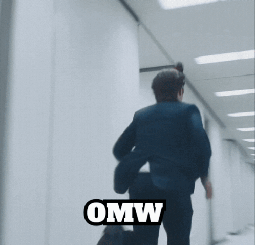 A Blurry Picture Of A Man Jumping With The Word Omw Below Him GIF