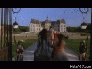 A Blurry Picture Of A Man Riding A Horse In Front Of A Castle With The Website Makeagif.com Visible GIF