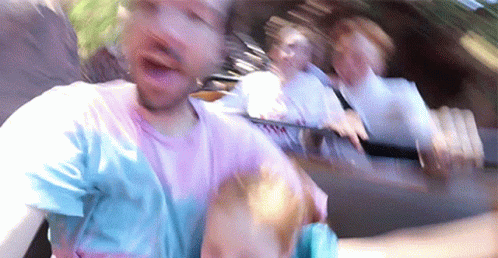 A Blurry Picture Of A Man Riding A Roller Coaster . GIF