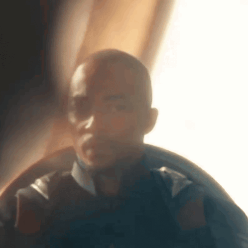A Blurry Picture Of A Man 'S Face In A Dark Room . GIF