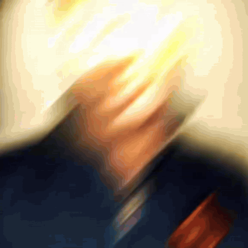 A Blurry Picture Of A Man 'S Face With A Light Coming Out Of It GIF