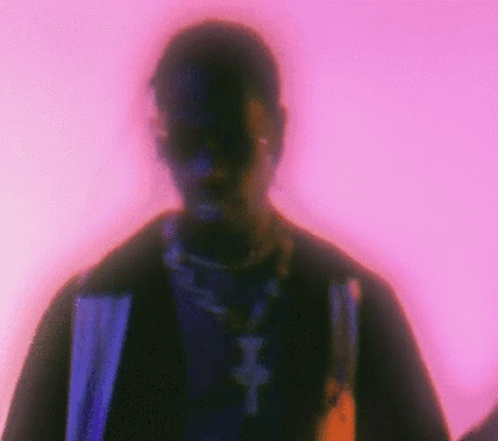 A Blurry Picture Of A Man 'S Face With A Purple Background . GIF
