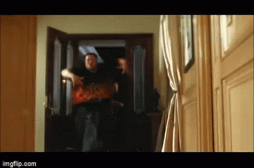 A Blurry Picture Of A Man Standing In A Doorway With Imgflip.com In The Lower Right Corner GIF
