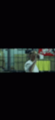 A Blurry Picture Of A Man Taking A Selfie In A Mirror . GIF
