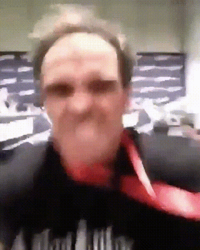 A Blurry Picture Of A Man Wearing A Black Shirt That Says ' A ' On The Front GIF