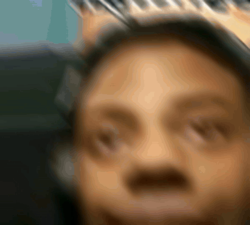 a blurry picture of a man wearing a crown on his head
