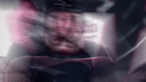 A Blurry Picture Of A Man Wearing A Helmet And A Jacket . GIF