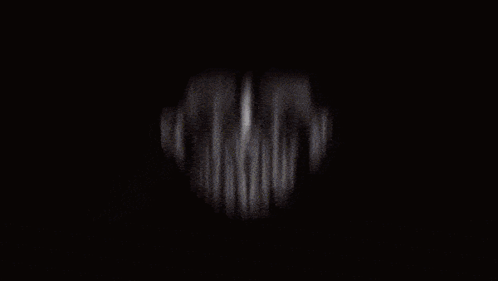 A Blurry Picture Of A Man Wearing A Red Shirt GIF