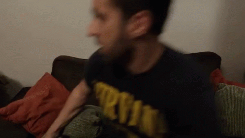 A Blurry Picture Of A Man Wearing A Shirt That Says ' Army ' On It GIF