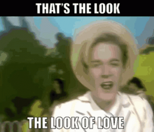A Blurry Picture Of A Man Wearing A Straw Hat With The Words That 'S The Look The Look Of Love GIF
