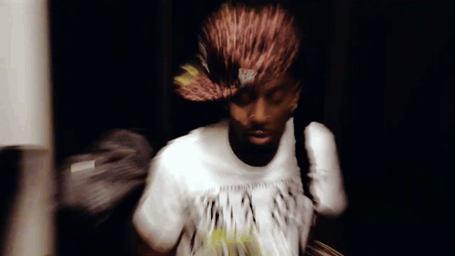 a blurry picture of a man wearing a t-shirt that says ' a ' on it