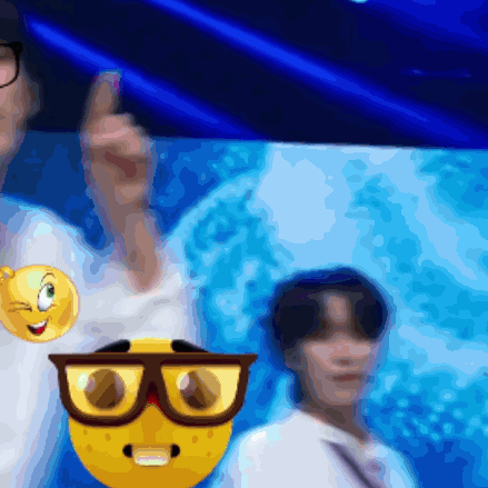 A Blurry Picture Of A Man Wearing Glasses And A Smiley Face On His Shirt GIF