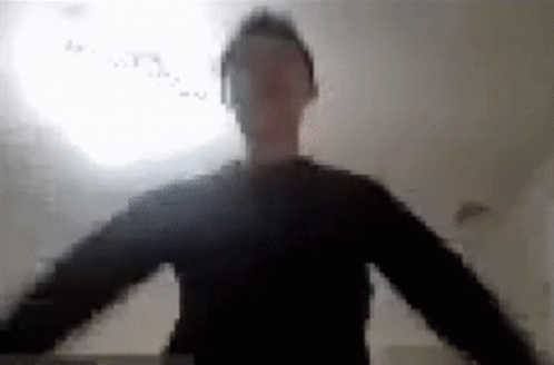 A Blurry Picture Of A Man Wearing Headphones And A Black Shirt . GIF