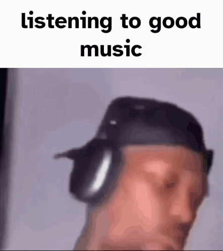 A Blurry Picture Of A Man Wearing Headphones And A Hat . GIF