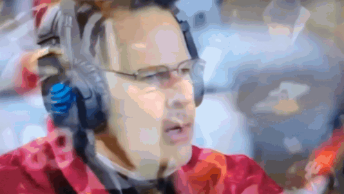 A Blurry Picture Of A Man Wearing Headphones And A Headset With The Number 18 On It GIF