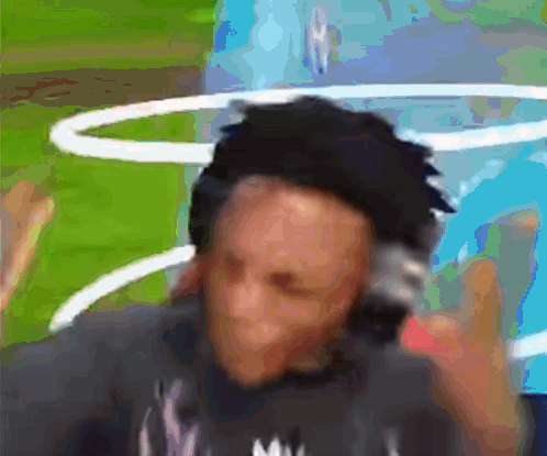 A Blurry Picture Of A Man Wearing Headphones And A Shirt That Says ' Mv ' On It GIF