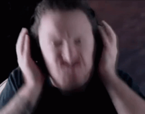 A Blurry Picture Of A Man Wearing Headphones . GIF