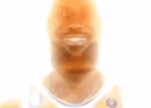 A Blurry Picture Of A Man With A Beard Wearing A White Jersey With A Eagle On It GIF