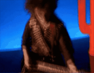 A Blurry Picture Of A Man With A Gun And A Cactus In The Background GIF