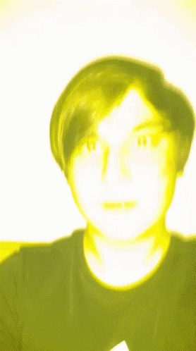 A Blurry Picture Of A Man With A Yellow Face GIF
