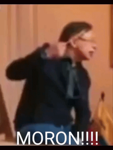 A Blurry Picture Of A Man With The Word Moron Written On The Bottom GIF