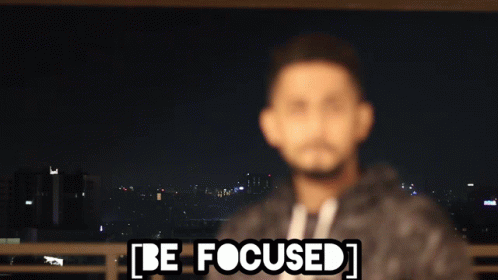 A Blurry Picture Of A Man With The Words Be Focused Written Above Him GIF