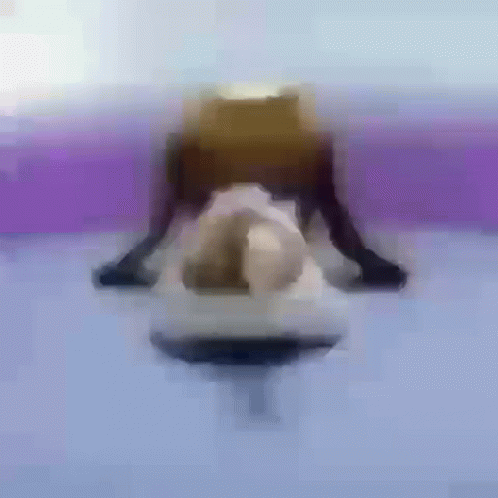 A Blurry Picture Of A Person Doing A Yoga Pose On A Purple Surface . GIF