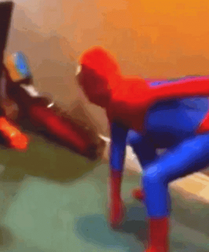 A Blurry Picture Of A Person Dressed As A Spiderman GIF