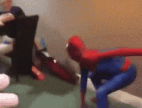 A Blurry Picture Of A Person Dressed As Spider Man GIF