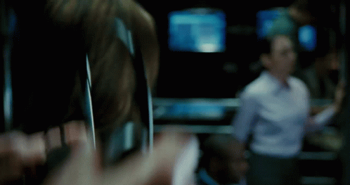 A Blurry Picture Of A Person Holding A Cell Phone In A Dark Room GIF