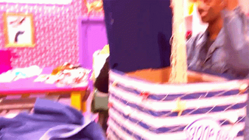 A Blurry Picture Of A Person Holding A Striped Blanket GIF