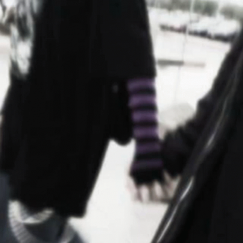 A Blurry Picture Of A Person Holding Another Person 'S Hand In The Snow . GIF