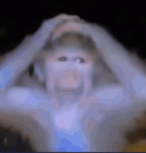 A Blurry Picture Of A Person Holding Their Head With Their Hands GIF