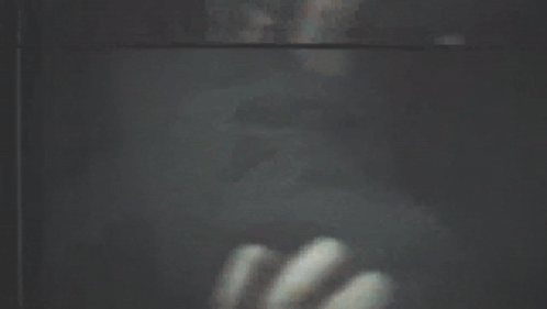 a blurry picture of a person looking out of a window