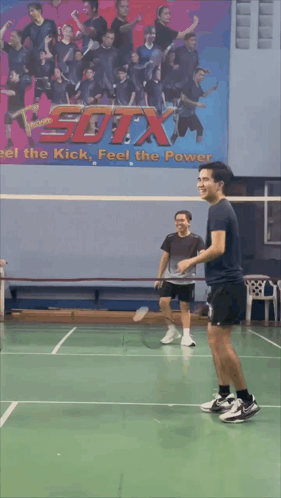 A Blurry Picture Of A Person Playing Badminton With A Picture Of A Bird On The Wall Behind Them GIF