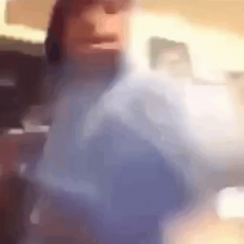 A Blurry Picture Of A Person 'S Face And Shoulder GIF
