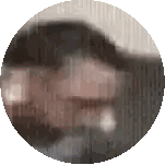 a blurry picture of a person 's face in a circle .