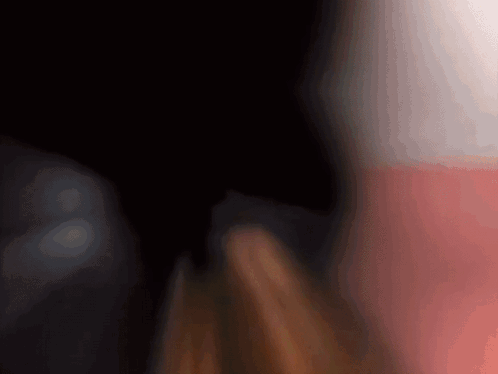 A Blurry Picture Of A Person 'S Face With A Red And White Background GIF