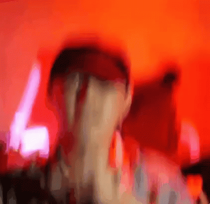 A Blurry Picture Of A Person 'S Face With A Red Background GIF