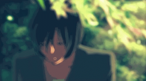 A Blurry Picture Of A Person 'S Face With Leaves In The Background GIF