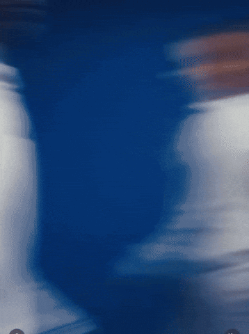a blurry picture of a person 's torso in a blue background