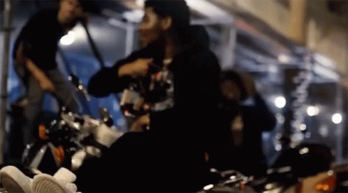 A Blurry Picture Of A Person Sitting On A Bike GIF