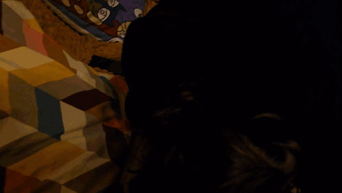 A Blurry Picture Of A Person Sitting On A Couch With Their Legs Crossed GIF