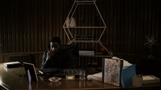 A Blurry Picture Of A Person Standing In A Dark Room . GIF