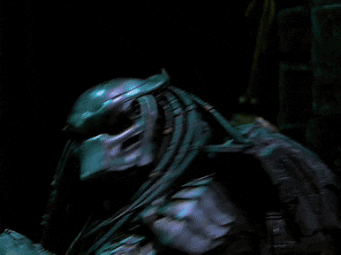A Blurry Picture Of A Person Standing In A Dark Room With A Few Lights Behind Them GIF