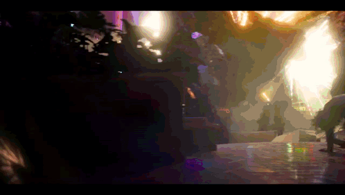 A Blurry Picture Of A Person Standing In A Dark Room With A Purple Light Behind Them GIF