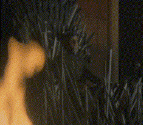 A Blurry Picture Of A Person Standing In A Field Of Tall Grass . GIF