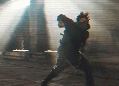 A Blurry Picture Of A Person Standing In Front Of A Building . GIF