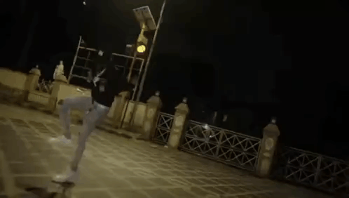 A Blurry Picture Of A Person Standing Next To A Table . GIF